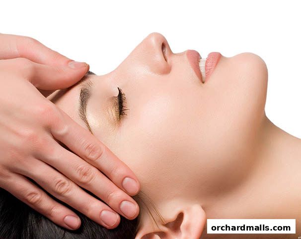A close-up of a person receiving a gentle facial massage.