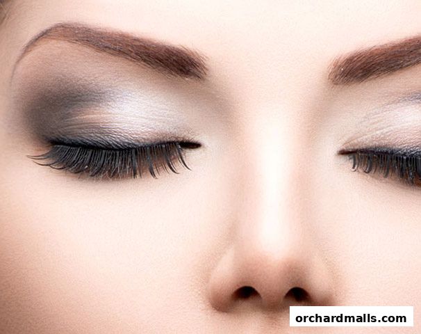 Close-up of a woman's eyes with dramatic makeup and false eyelashes.