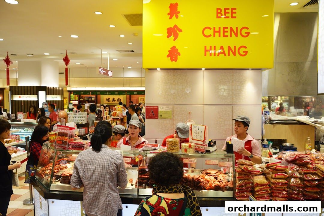 Bee Cheng Hiang shop with customers and staff serving meat products.