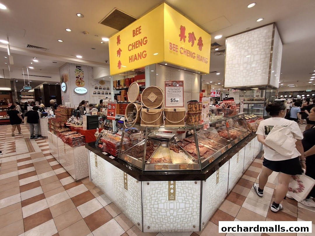 Bee Cheng Hiang shop display featuring various meat products and promotional signage.