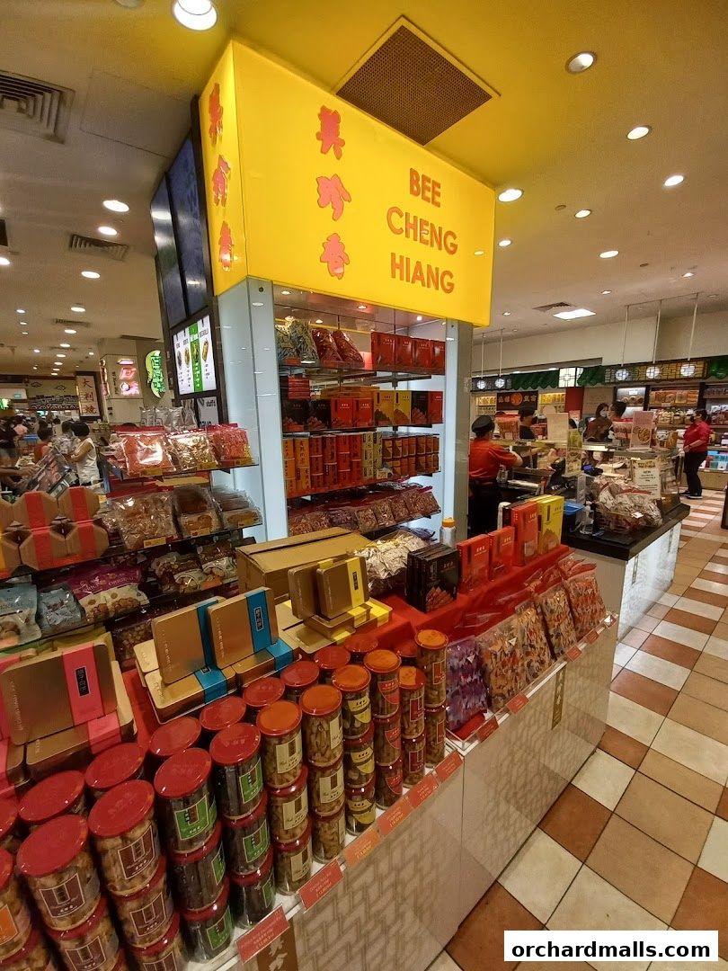 Bee Cheng Hiang shop interior showcasing various packaged food products and gift boxes.