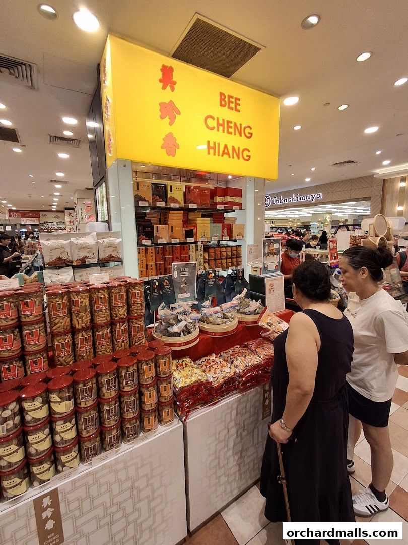 Bee Cheng Hiang shop display with various snacks and gift boxes.