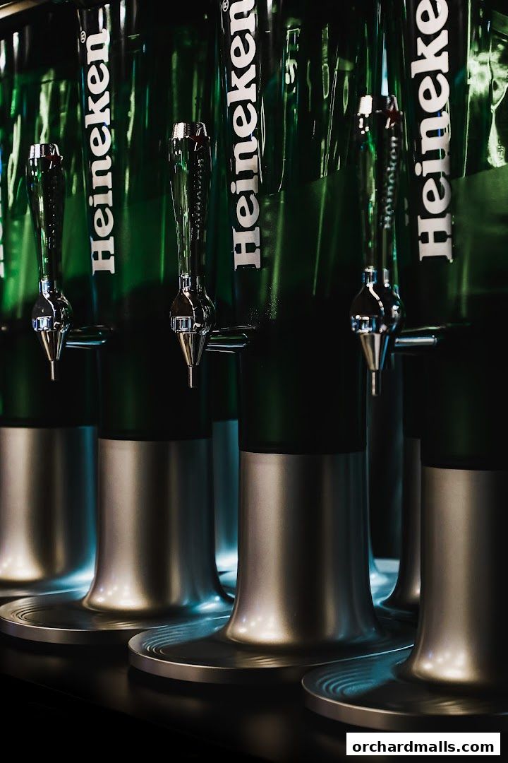 A close-up shot of multiple Heineken beer taps lined up.