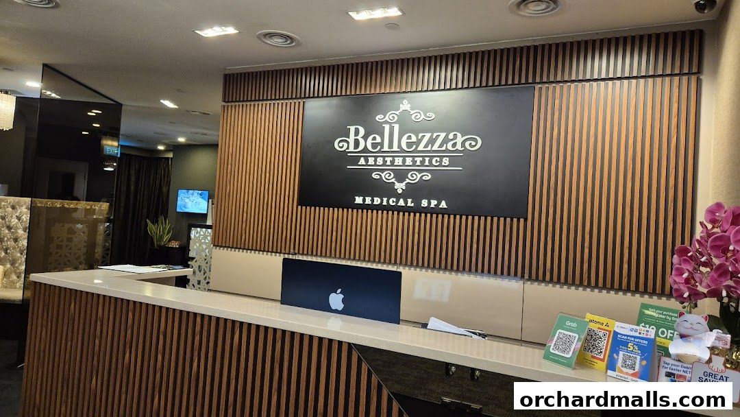 The reception area of Bellezza Aesthetics Medical Spa with a prominent logo and wooden accents.