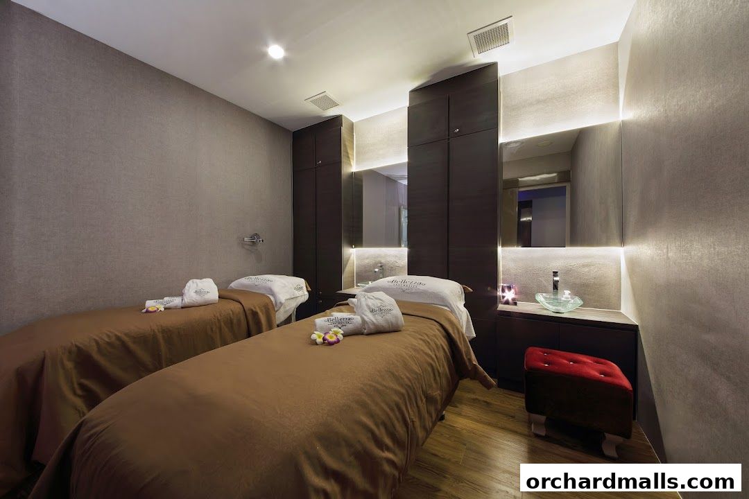 A serene spa room with two massage beds, plush towels, and ambient lighting.