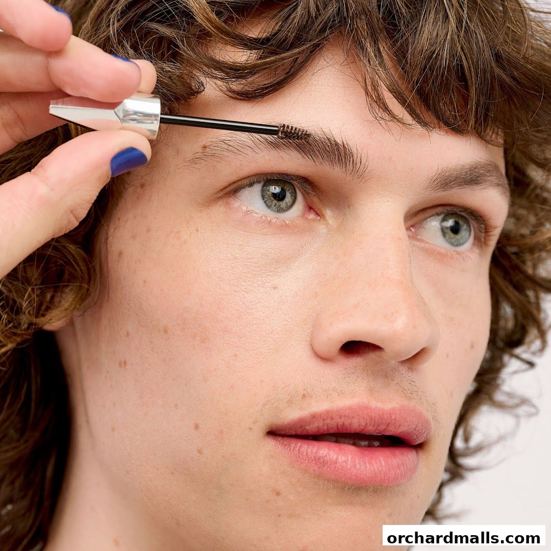 A close-up of a person's face as their eyebrows are being groomed.