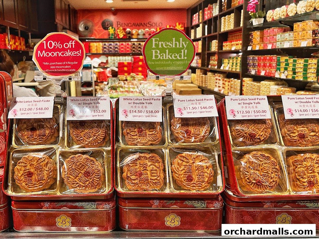 A display of freshly baked mooncakes with various flavors and prices at Bengawan Solo.