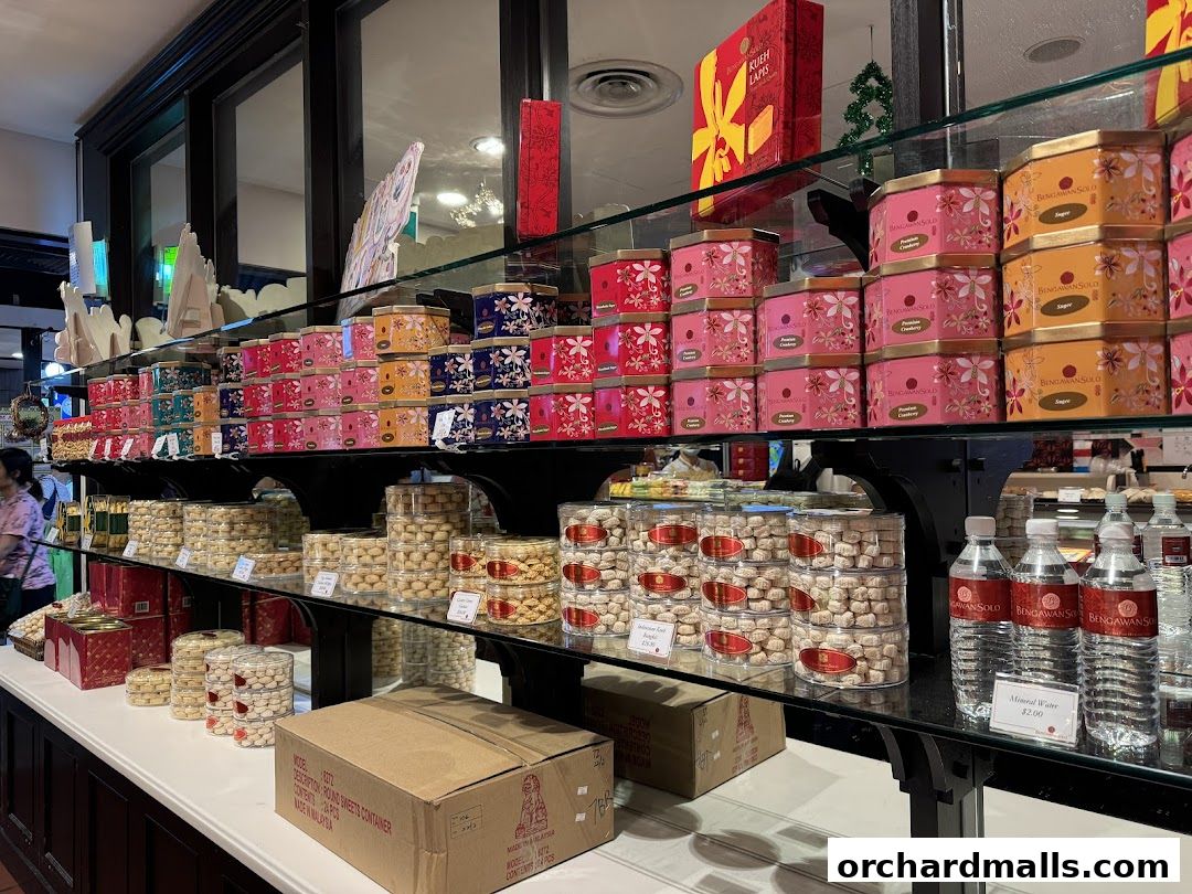 A display of colorful tins and jars filled with cookies and bottled water.