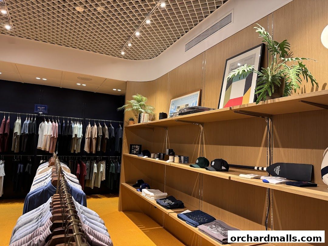 Interior view of Benjamin Barker clothing store with racks of shirts and display shelves.
