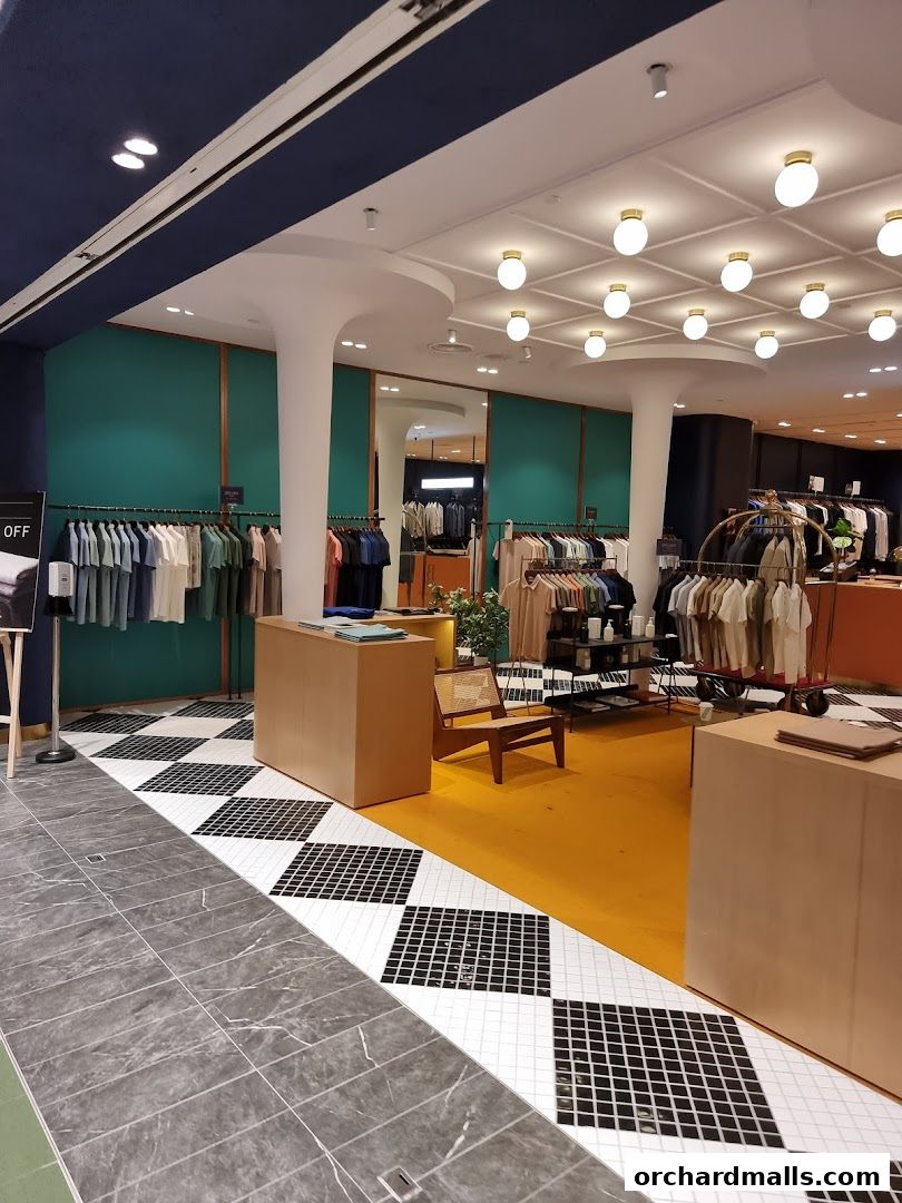 Interior view of a clothing store with racks of apparel and a modern, minimalist design.