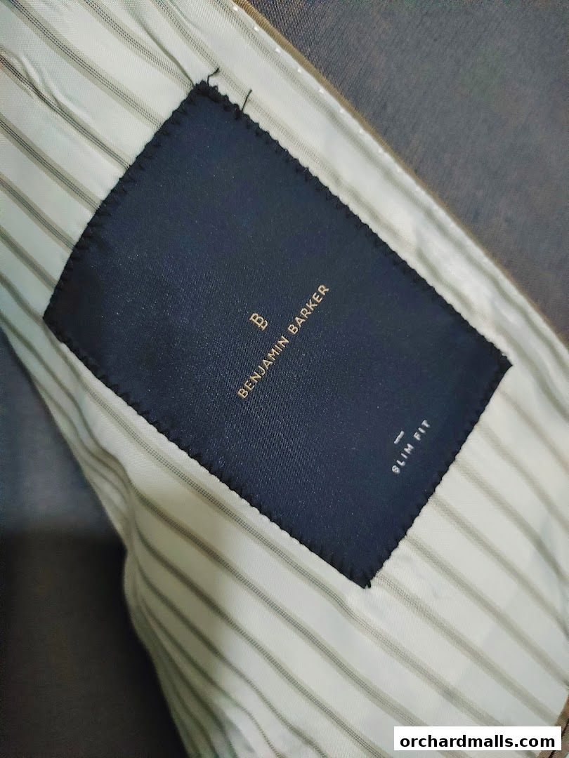 Close-up of a Benjamin Barker label inside a suit jacket, indicating a slim fit.