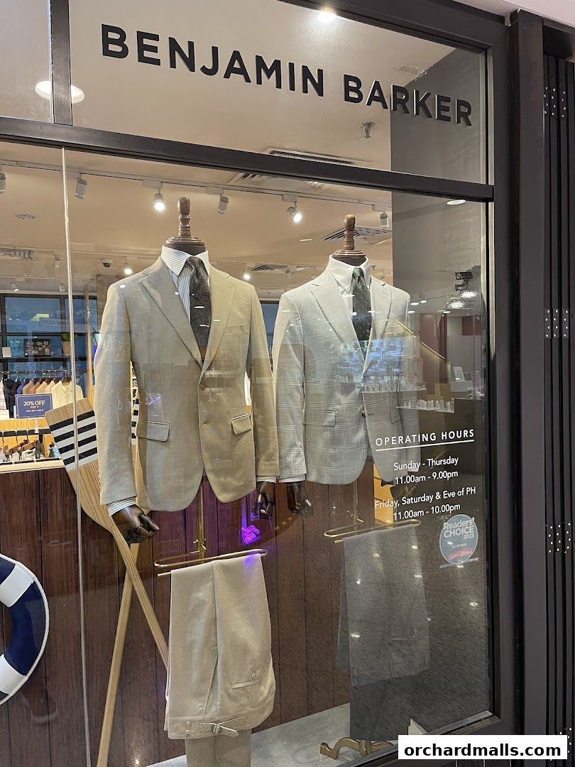 Benjamin Barker store window display featuring two mannequins in suits and operating hours.