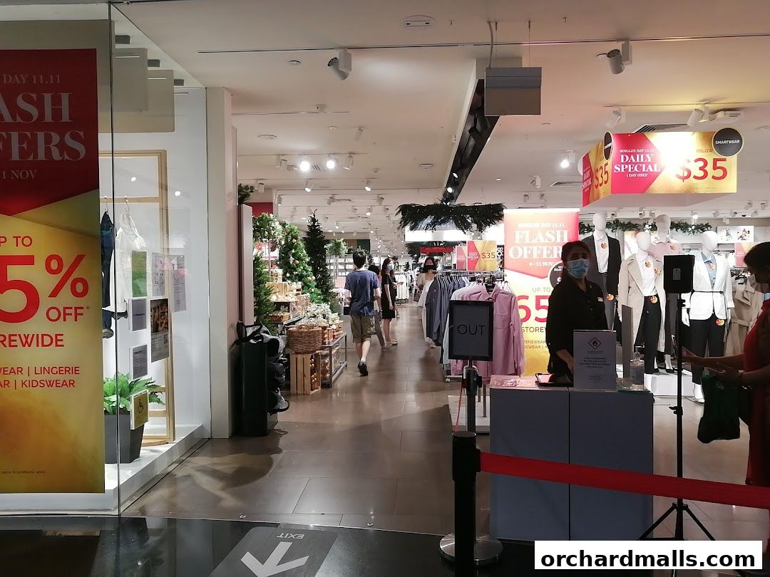 Benjamin Barker shop interior with sale signs and mannequins displaying clothing.