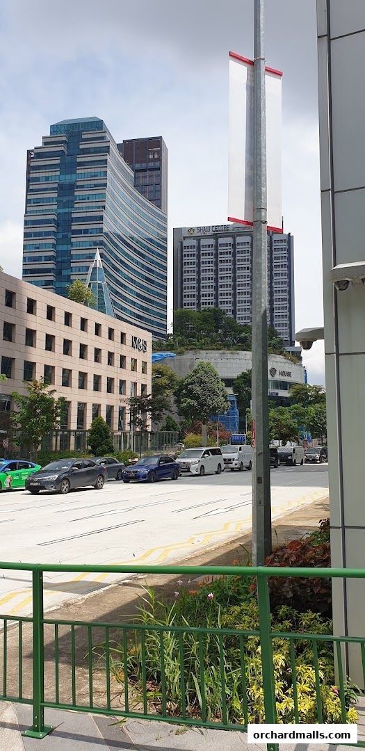 Street view of Benjamin Barker shop front with buildings and traffic.
