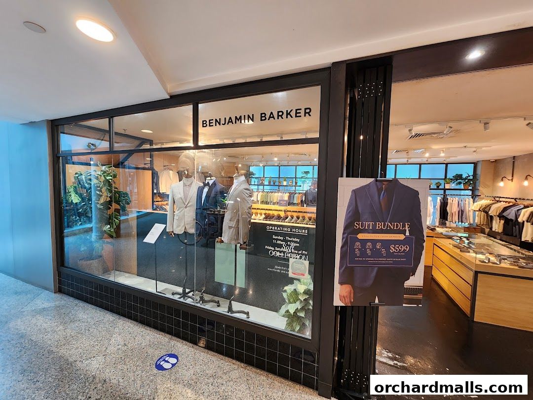 Benjamin Barker store window display featuring mannequins in suits and a suit bundle promotion.