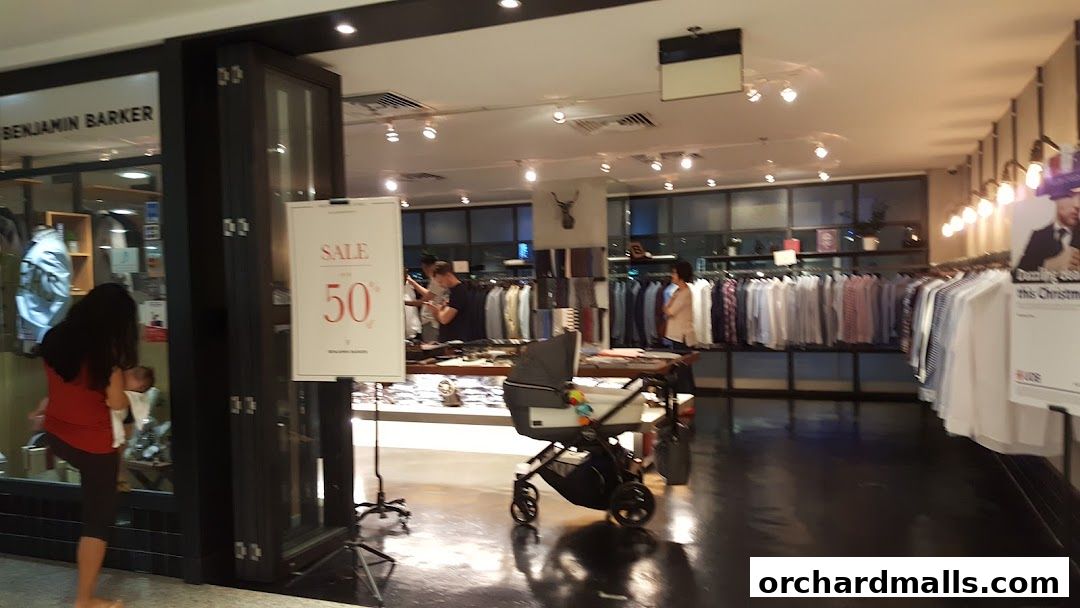 Benjamin Barker store interior with racks of shirts and a sale sign.
