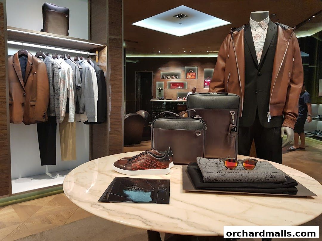A display of luxury men's fashion including suits, jackets, bags, shoes, and accessories.