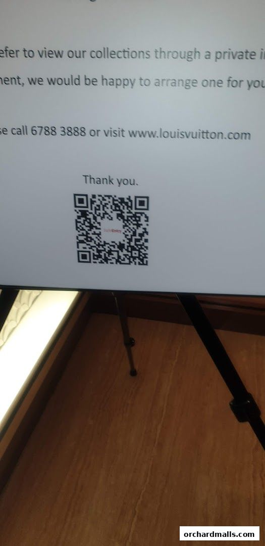 A screen displays text about viewing collections and a QR code for Louis Vuitton.
