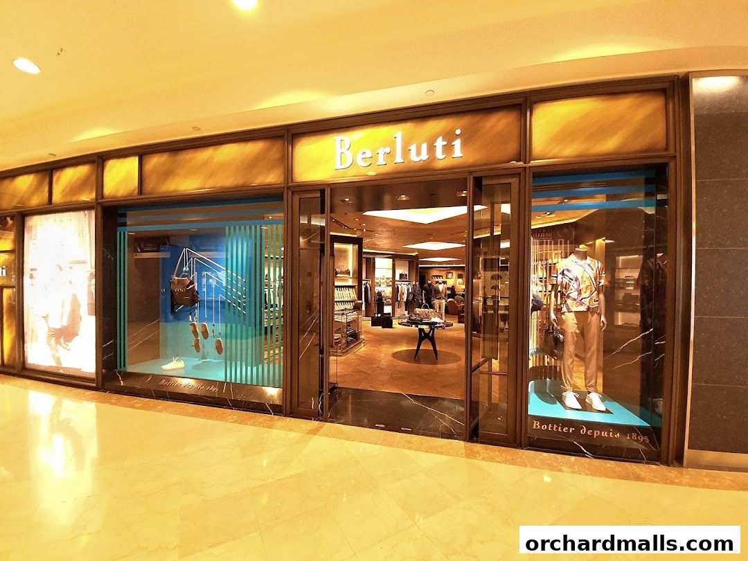 The elegant storefront of Berluti, showcasing luxury fashion and accessories.