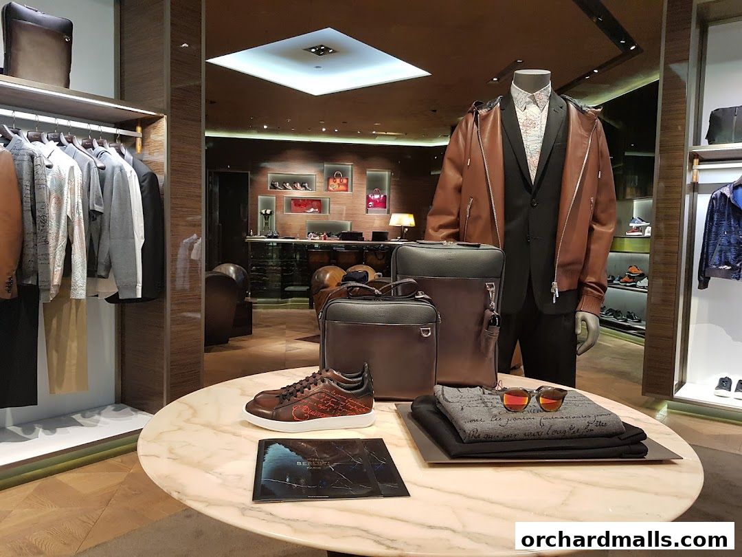 A display of luxury men's fashion items including clothing, bags, shoes, and accessories.