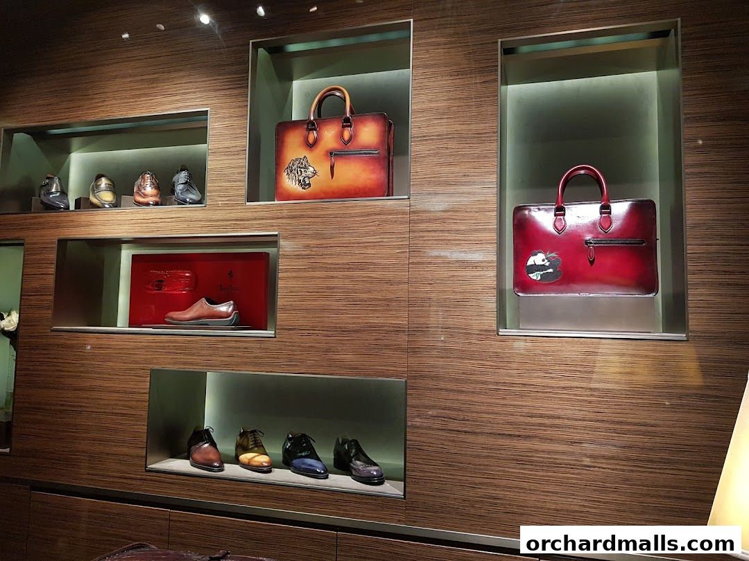 Luxurious Berluti store display featuring elegant leather shoes and handbags.