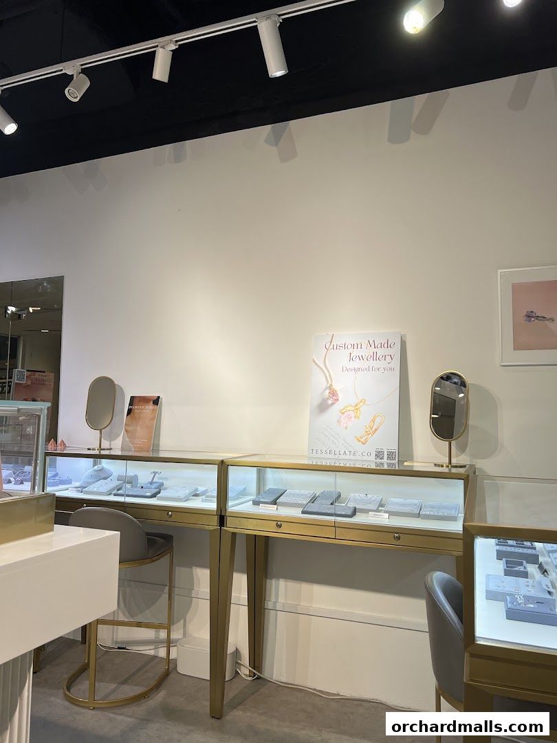 Interior view of a jewelry store with display cases showcasing necklaces and rings.