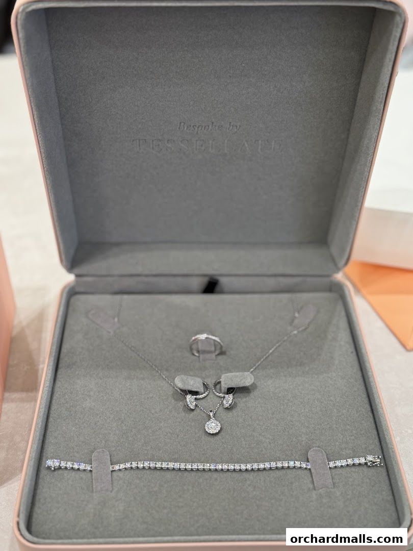 A jewelry box displaying a diamond necklace, earrings, ring, and bracelet.