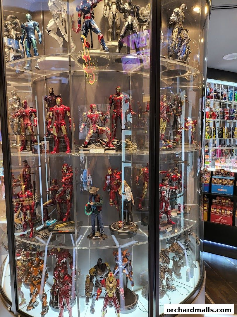 A display case filled with various action figures, primarily Iron Man and other Marvel characters.