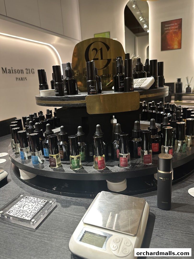 A display of small perfume bottles and a digital scale at Maison 21G.
