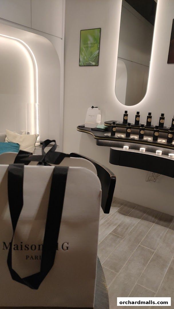 Interior of a modern fragrance boutique with a shopping bag in the foreground.