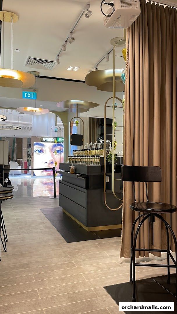 Interior of a modern fragrance boutique with perfume bottles displayed.