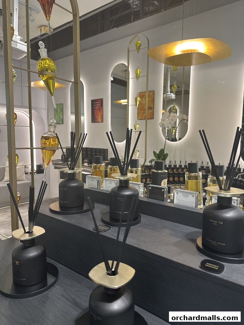 Elegant display of Maison 21G bespoke fragrances and diffusers in a modern retail setting.