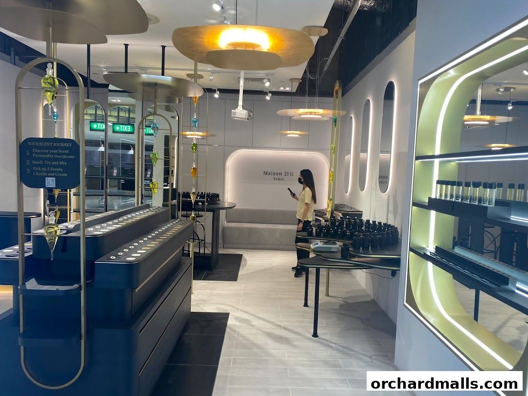 Interior of a modern perfume boutique with a scent journey display and a customer.