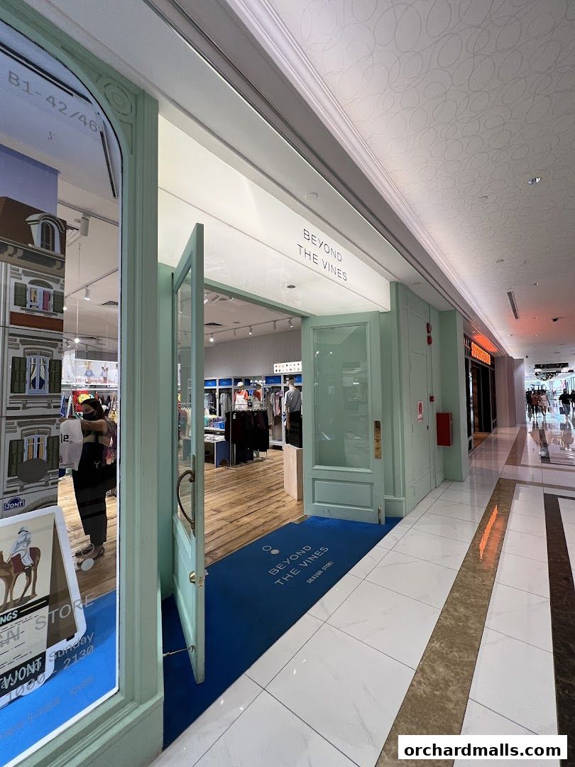 The entrance to Beyond The Vines Design Post, a stylish shop with open doors and displays of clothing.