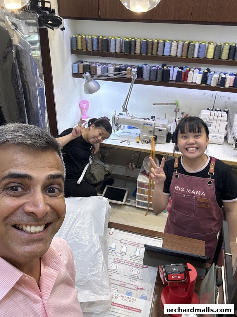 Staff at Big Mama Ngee Ann City laundry and dry cleaning service posing for a photo.