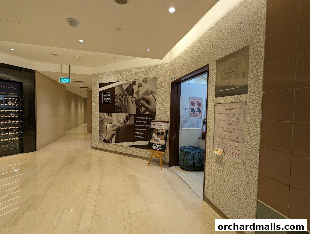 A hallway in a mall with a shop entrance and a menu displayed on the wall.