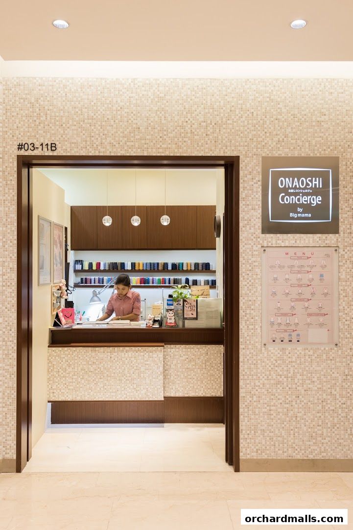 A concierge desk with a staff member and a menu displayed on the wall.