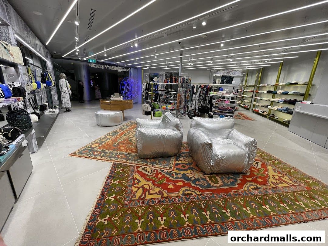Interior view of a BIMBA Y LOLA store with clothing, bags, and seating.