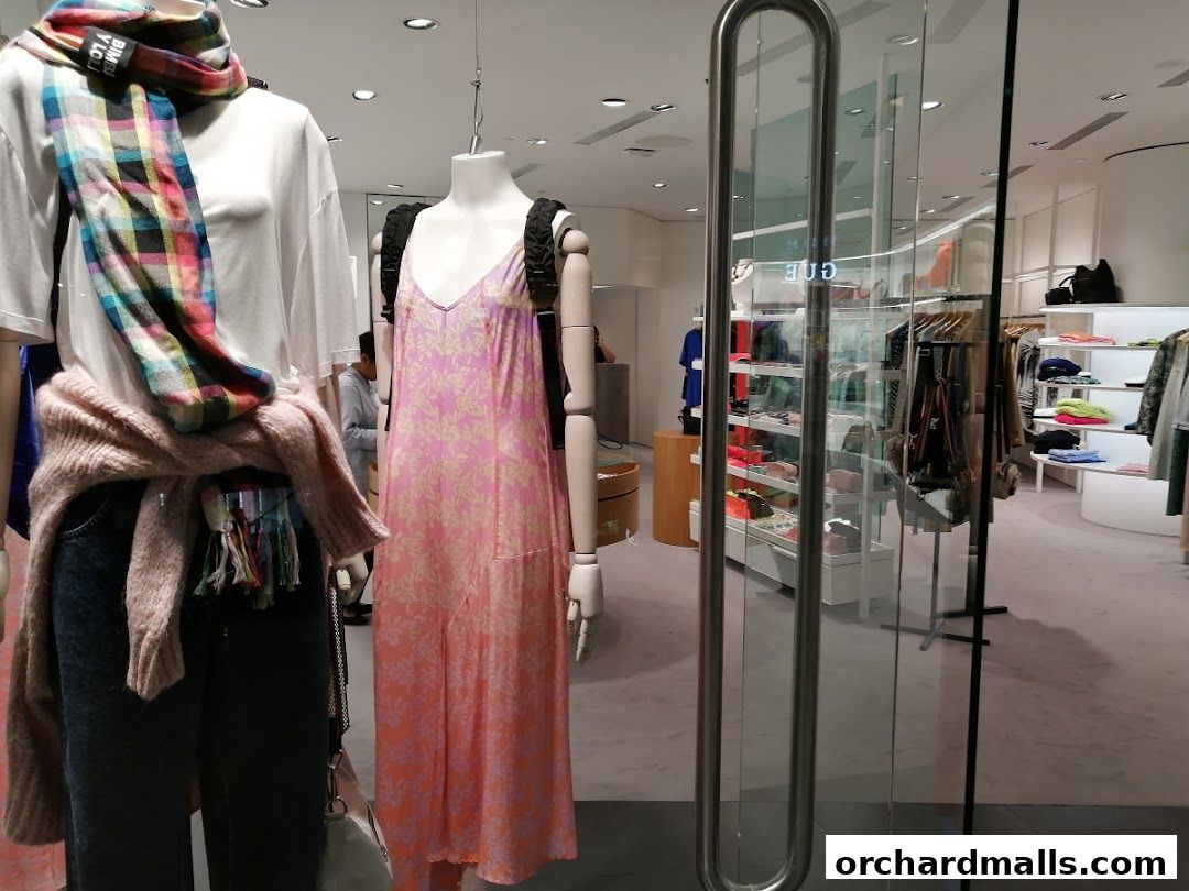 Mannequins display fashion items in a BIMBA Y LOLA store window.