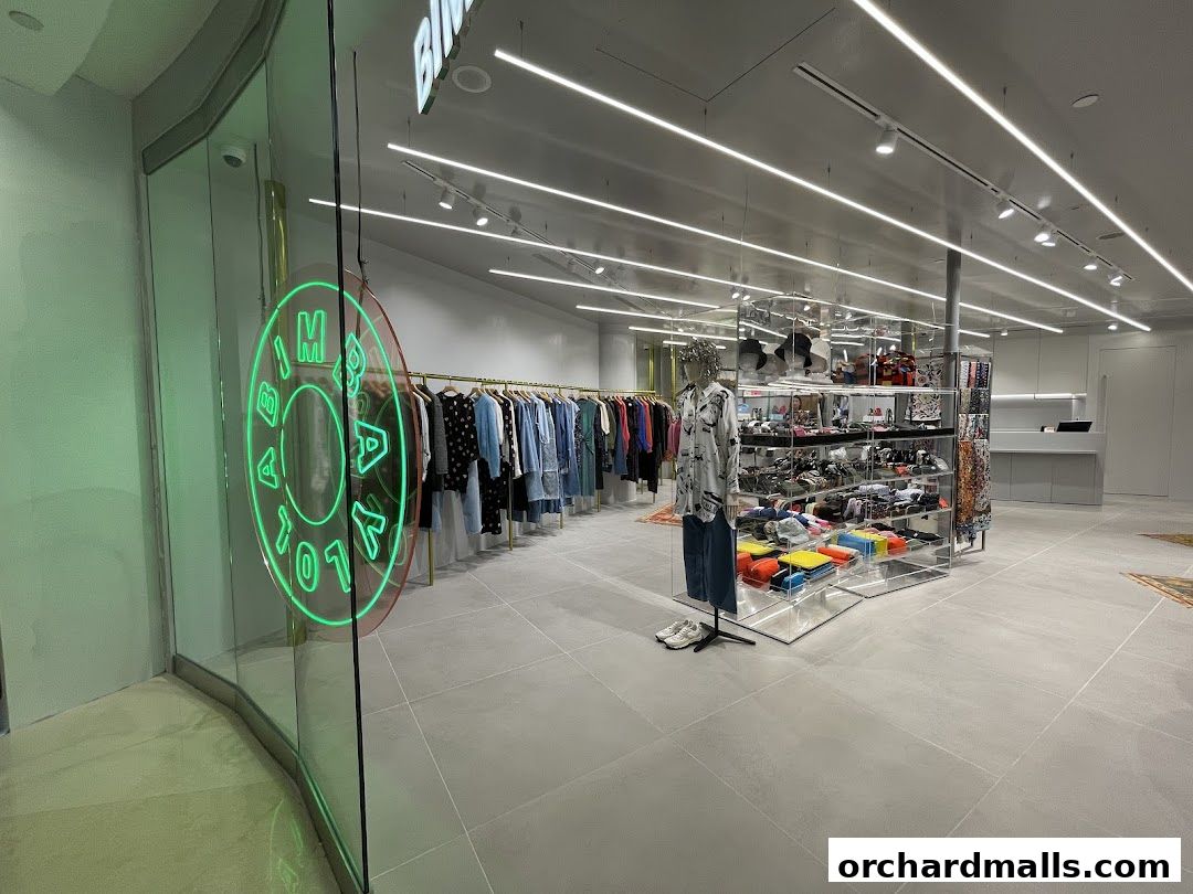 Interior view of BIMBA Y LOLA shop showcasing clothing on racks and display shelves.