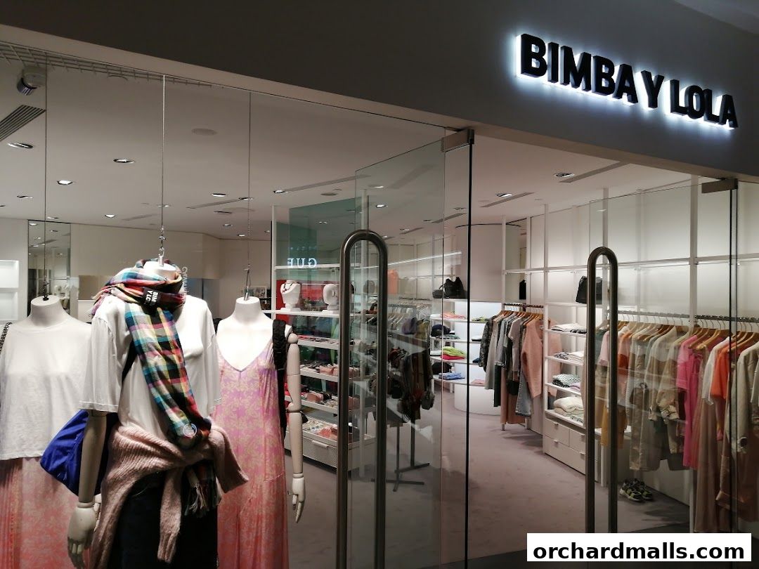 The BIMBA Y LOLA shop front displays mannequins with stylish clothing and a well-organized interior.