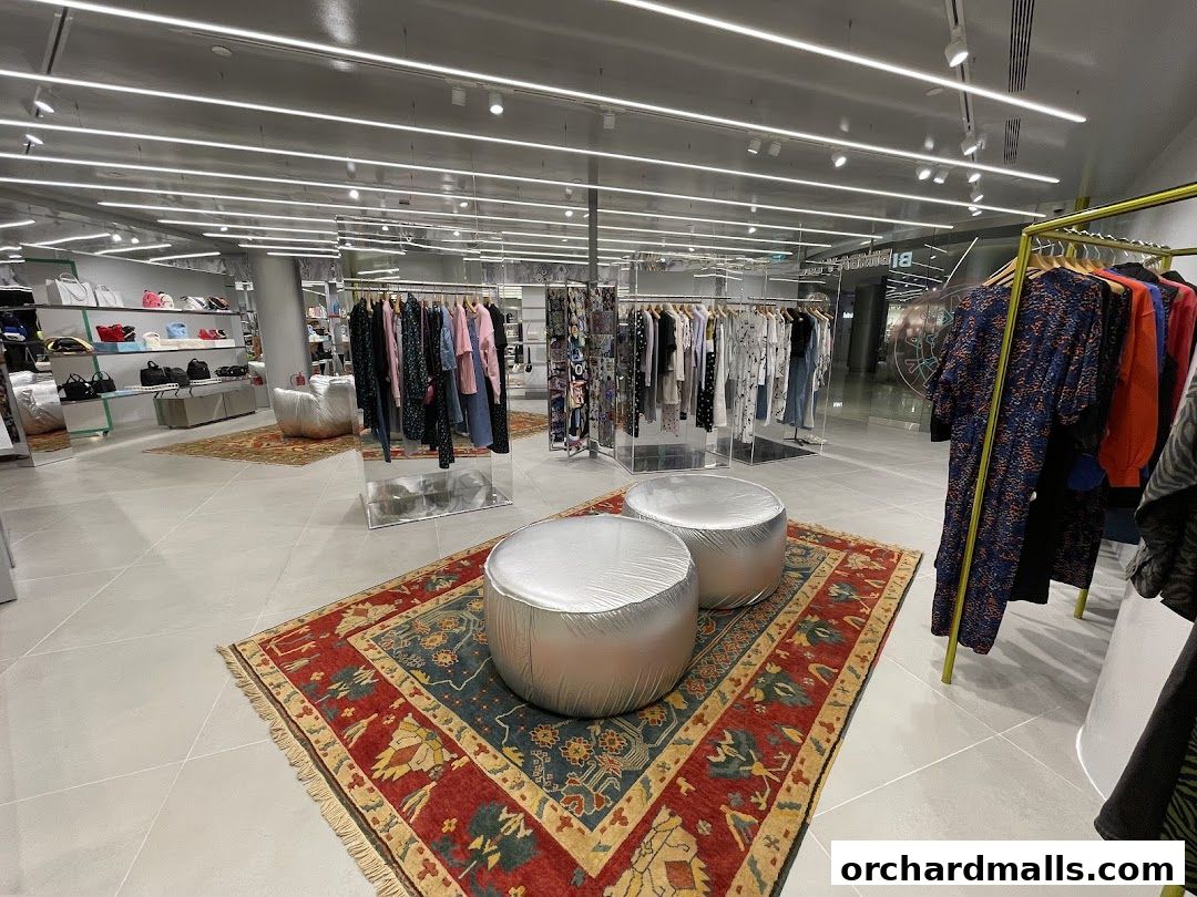Interior view of a stylish clothing store with racks of apparel and display shelves.