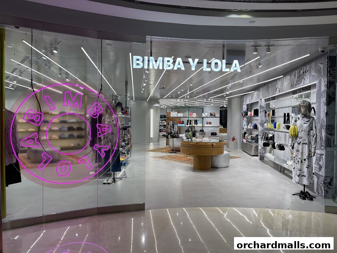 The BIMBA Y LOLA store features a modern interior with clothing and accessories displayed on shelves and mannequins.