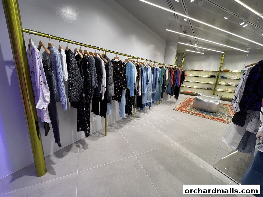 Interior view of a BIMBA Y LOLA store showcasing a variety of clothing on racks and shelves.