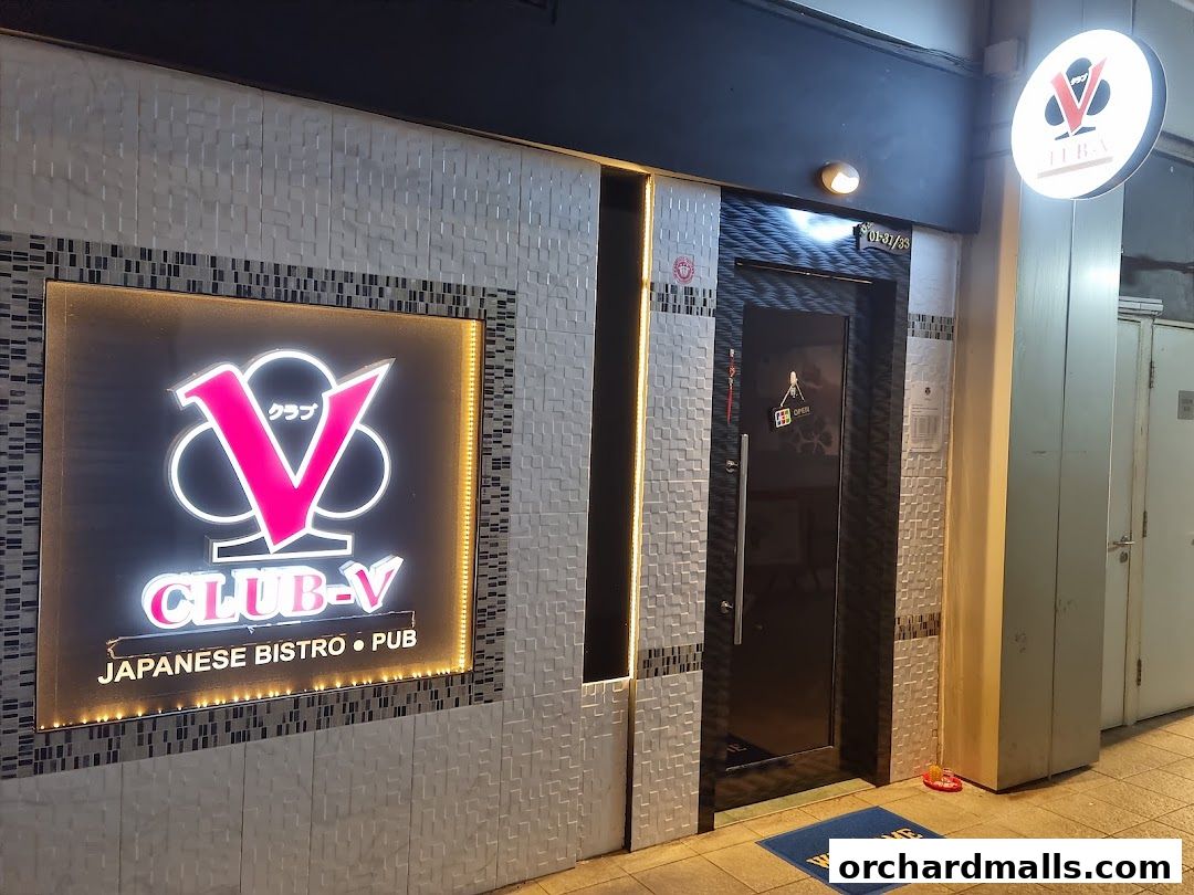 Exterior of Club-V, a Japanese Bistro and Pub, with a prominent neon sign.