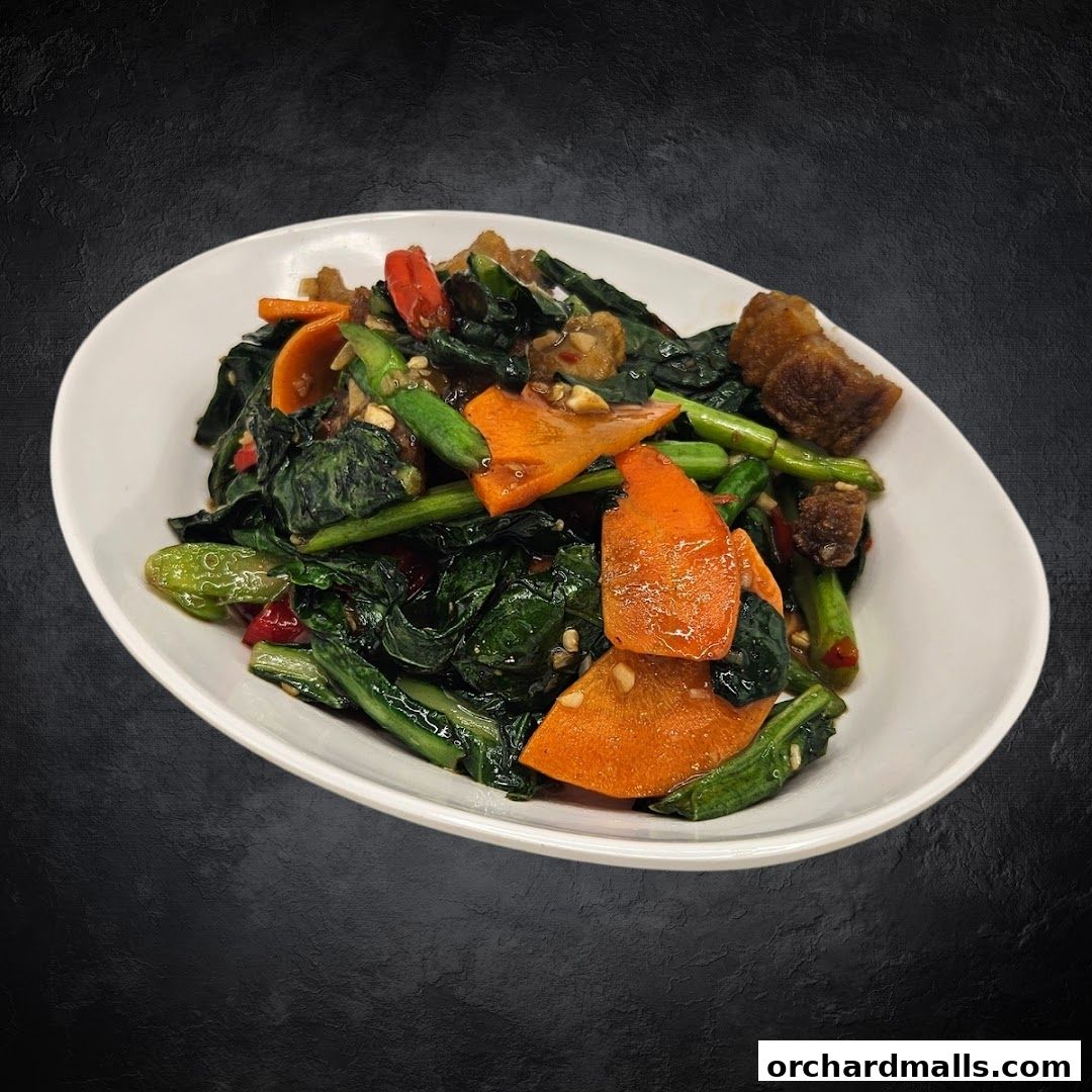 A white bowl filled with stir-fried vegetables and crispy pork, seasoned with chili.