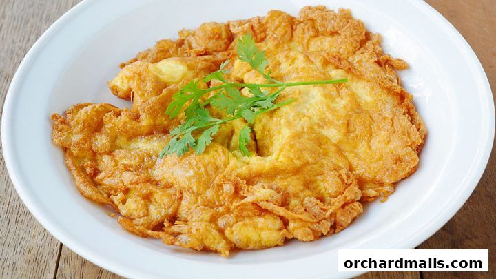 A close-up shot of a golden-brown omelet garnished with fresh cilantro on a white plate.