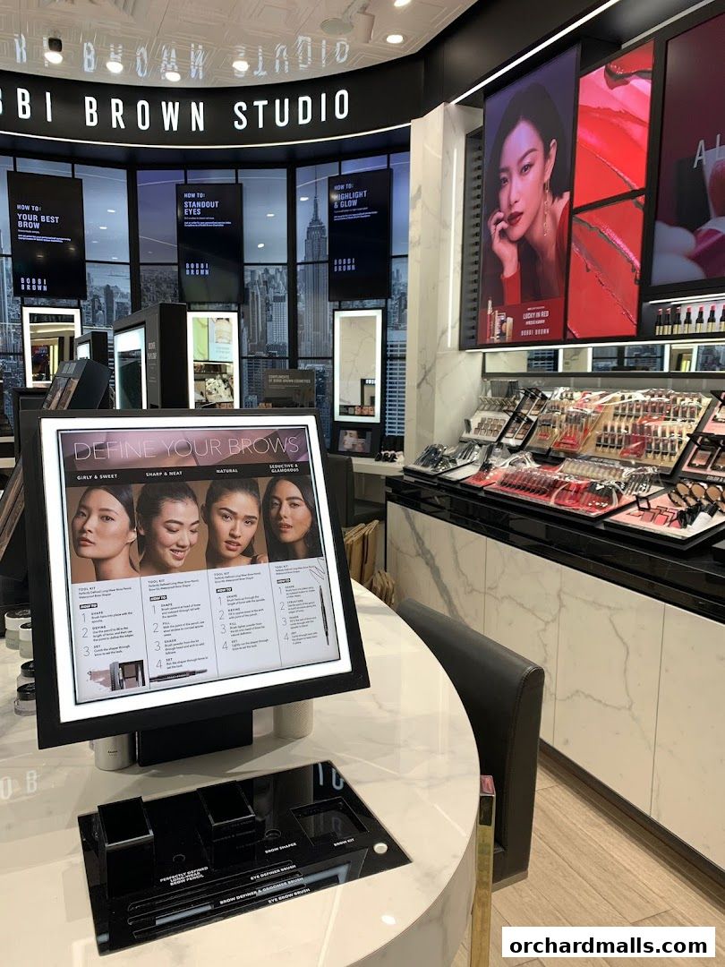 Interior of a Bobbi Brown Studio showcasing makeup products and tutorials.
