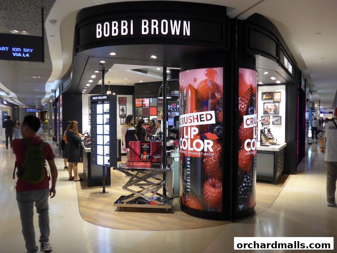 The Bobbi Brown store entrance with displays of makeup and berry-themed advertising.