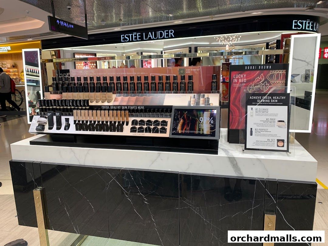 Bobbi Brown makeup display featuring foundations and skincare products with promotional signage.